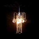 Glimmering Modern Chandelier with Round Metal Frame and Strands of Clear Crystal Beads and Faceted Orbs