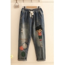 Unique Women's Drawstring Waist Cartoon Embroidered Bleach Rolled Edge Cuffs Carrot Fit Jeans in Blue