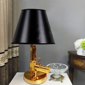 Black Tapered Table Light Modernism 1-Bulb Fabric Nightstand Lamp with Resin Gun-Shaped Design