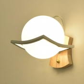 Yellow Glass Globe 1-Light Modern Wall Sconce for a Stylish Ambient Glow
