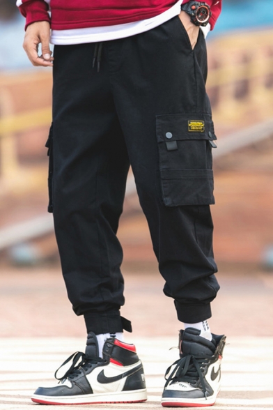 Elegant Men's Cargo Pants Label Detail Flap Pockets Ankle Tied Brushed Drawstring Waist Ankle Length Tapered Pants