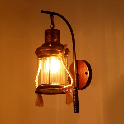 Industrial Wall Sconce with Lantern Style Metal Cage and Clear Glass Shade in Bronze