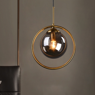 Ball Shaped Bedroom Pendant Light Clear/Smoke Grey/Amber Glass 1-Light Postmodern Hanging Lamp with Decorative Ring in Brass