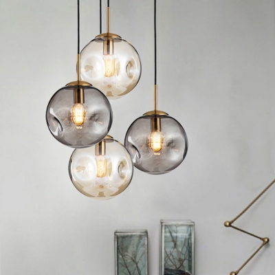 1-Light Living Room Suspension Lamp Postmodern Brass Hanging Pendant with Ball Dimpled Smoke Gray/Cognac Glass Shade