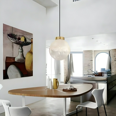 Golden Pendant Accentuated with Clear Glass Globe and Adjustable Cord Length for Modern Home Decor